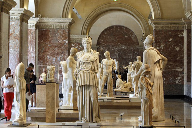 Visitors look at sculptures during the p